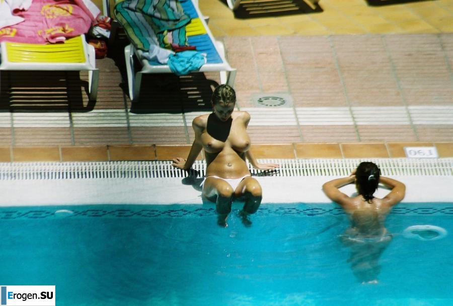 Girls sunbathe topless near the pool. Photo 11