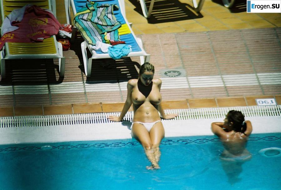 Girls sunbathe topless near the pool. Photo 15