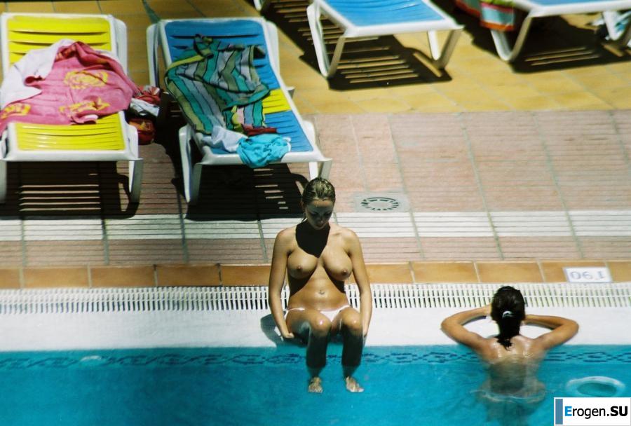 Girls sunbathe topless near the pool. Photo 17