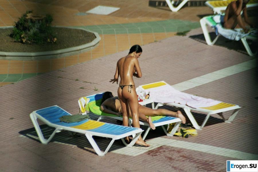 Girls sunbathe topless near the pool. Photo 22