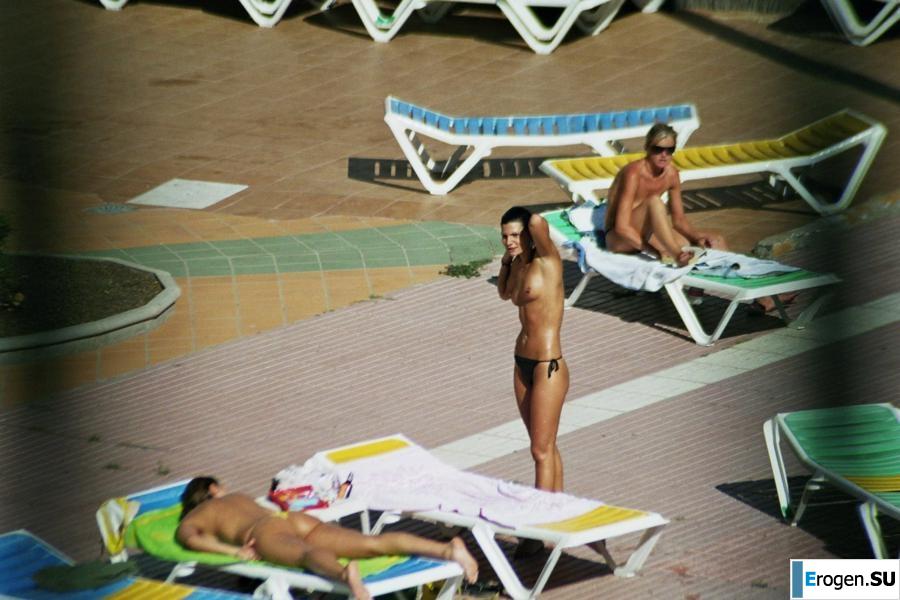 Girls sunbathe topless near the pool. Photo 24