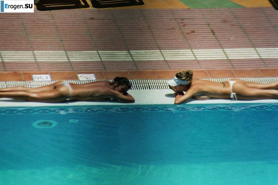 Girls sunbathe topless near the pool. Photo 26