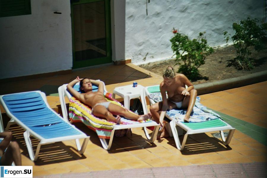 Girls sunbathe topless near the pool. Photo 28