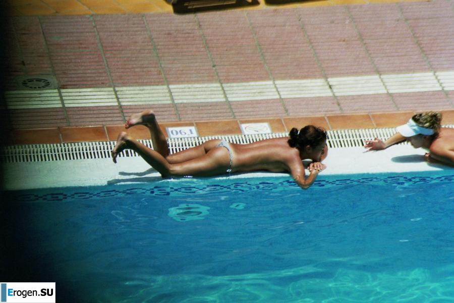 Girls sunbathe topless near the pool. Photo 29