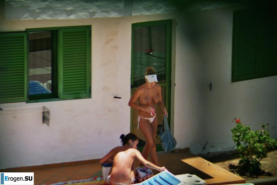 Girls sunbathe topless near the pool. Photo 33
