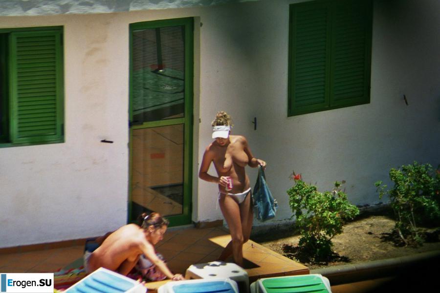 Girls sunbathe topless near the pool. Photo 34