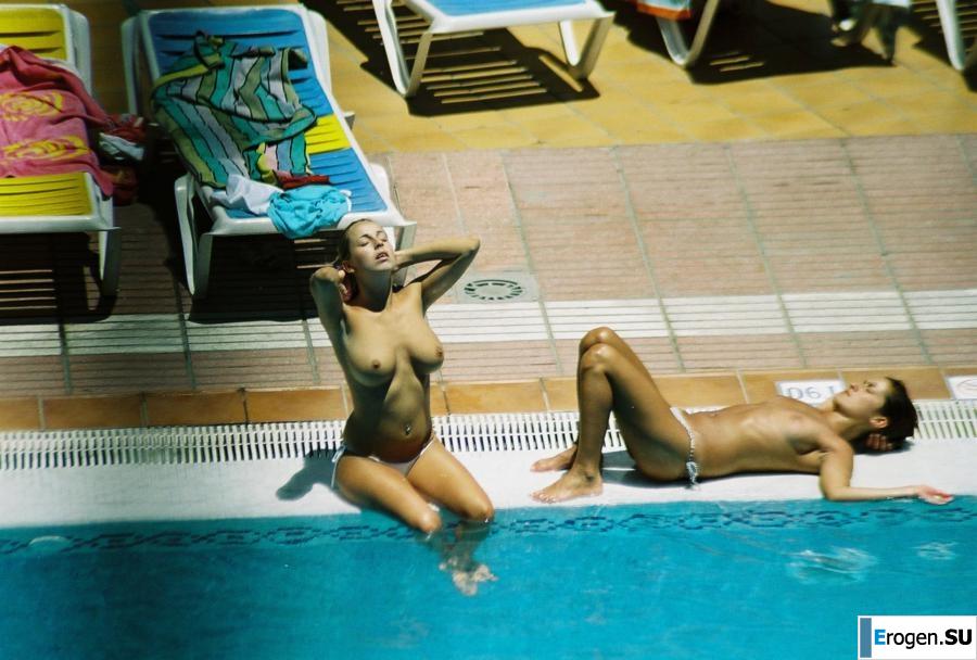 Girls sunbathe topless near the pool. Photo 4