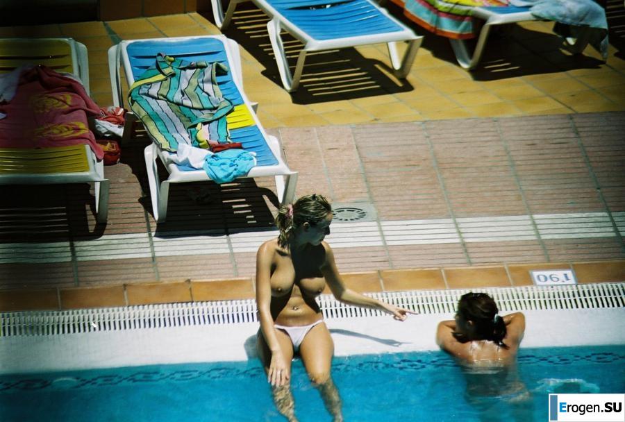 Girls sunbathe topless near the pool. Photo 8