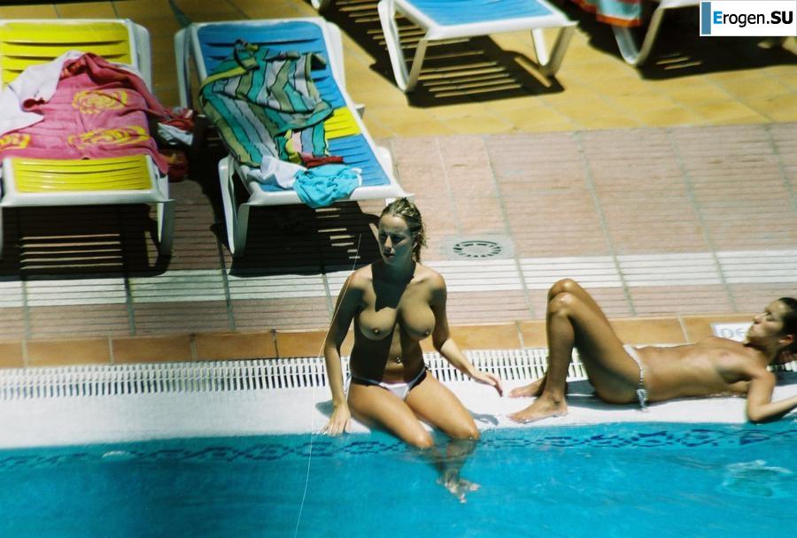 Girls sunbathe topless near the pool. Photo 9