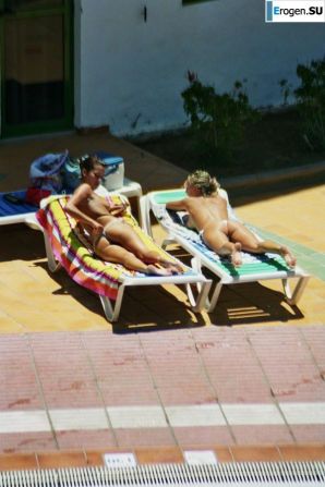 Girls sunbathe topless near the pool. Thumb 13