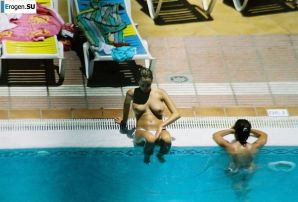 Girls sunbathe topless near the pool. Thumb 18