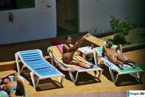 Girls sunbathe topless near the pool. Thumb 37