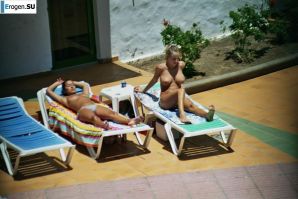 Girls sunbathe topless near the pool. Thumb 39