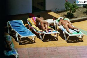Girls sunbathe topless near the pool. Thumb 40