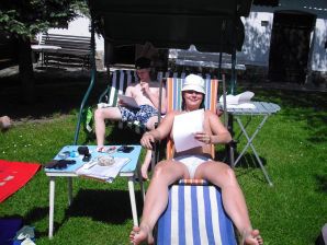 three girlfriends sunbathe in the yard with bare breasts. Thumb 1