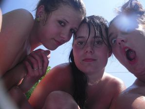 three girlfriends sunbathe in the yard with bare breasts. Thumb 11