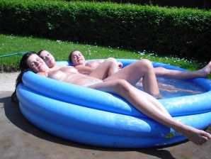 three girlfriends sunbathe in the yard with bare breasts. Thumb 16