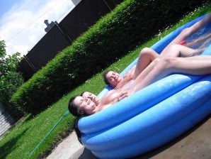 three girlfriends sunbathe in the yard with bare breasts. Thumb 17