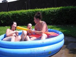 three girlfriends sunbathe in the yard with bare breasts. Thumb 19