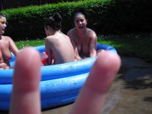 three girlfriends sunbathe in the yard with bare breasts. Thumb 23