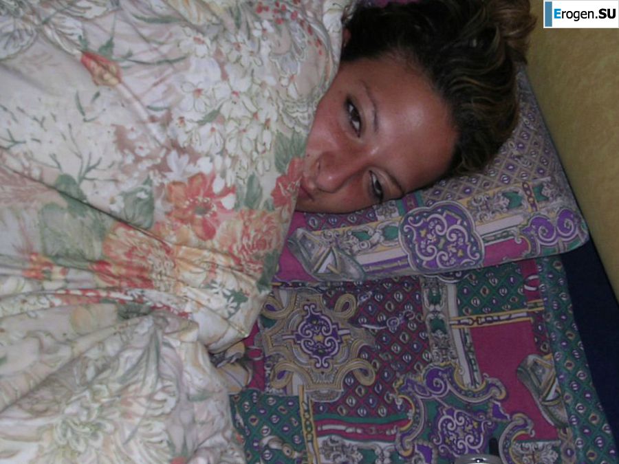 A tanned brunette shines her tits in the morning in bed. Photo 13