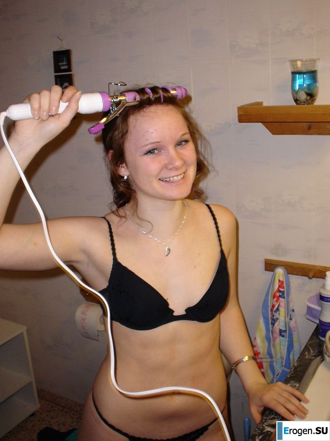 A blue-eyed minx with a pierced nipple plays with her panties. Photo 3