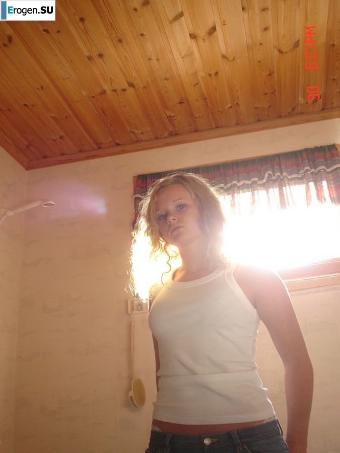 A blue-eyed minx with a pierced nipple plays with her panties. Photo 9