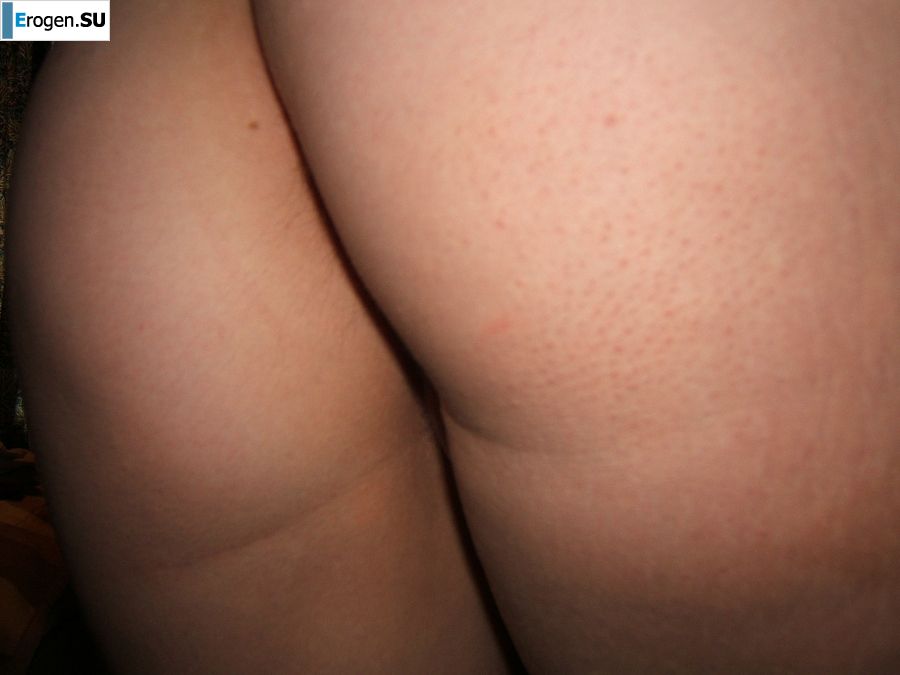 A slender blonde spreads her labia with her fingers. Photo 9