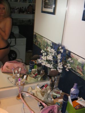 Chic blonde poses without a bra in the bathroom in front of the mirror. Thumb 11