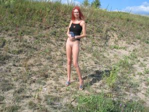 The red-haired beauty with a shaved pussy poses in one jacket. Thumb 27