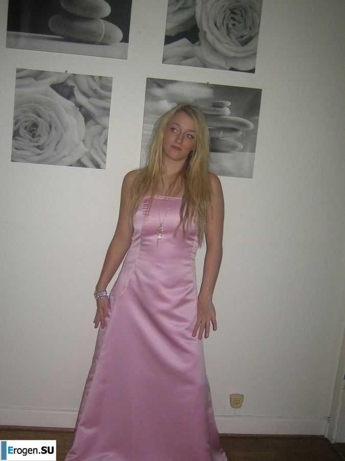 A blonde with silicone breast poses in a short skirt. Photo 16