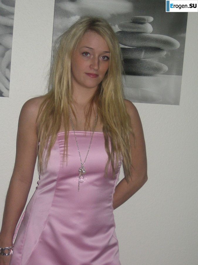 A blonde with silicone breast poses in a short skirt. Photo 17