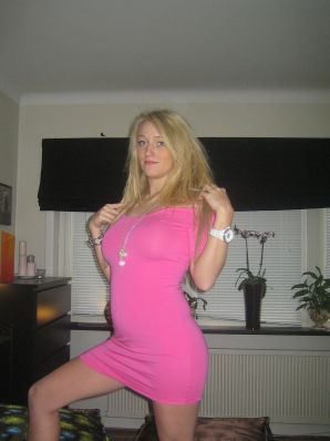 A blonde with silicone breast poses in a short skirt. Thumb 14