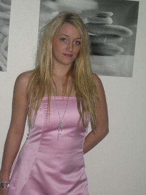A blonde with silicone breast poses in a short skirt. Thumb 17